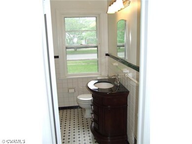 Bathroom - Updated full hall bath with classic B&W basket weave ceramic tile, new black granite vanity, and lighting.