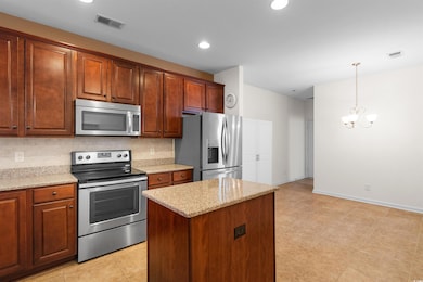 Kitchen with decorative backsplash, hanging light 
