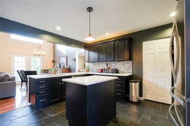 Slate floors with quartz countertops opening up to