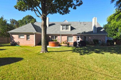 The beautiful backyard offers plenty of room for t