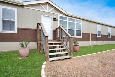 Doorway to property featuring a yard and crawl sp