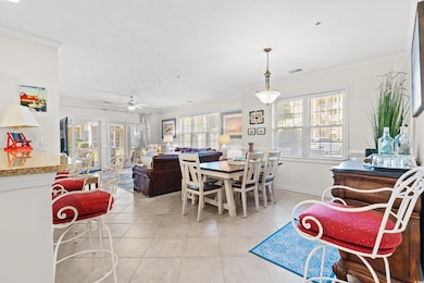 Tiled dining room with crown molding, ceiling fan, and a healthy amount of sunlight