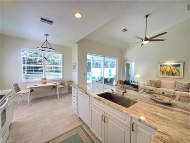 Kitchen featuring white dishwasher, white cabinets
