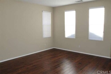 The spacious living room features wood floor, cust
