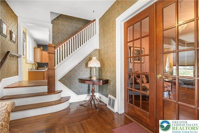 WELCOME, GREAT FOYER AND STAIRS TO SECOND FLOOR, A
