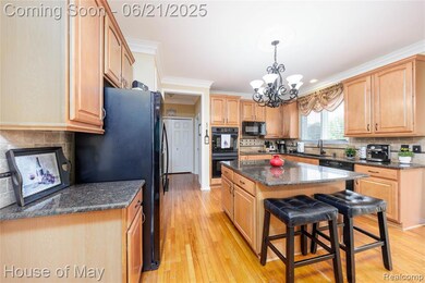 Large kitchen with granite countertops and hardwood flooring.
