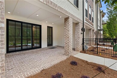 This inviting covered terrace-level patio features classic brick pavers that lend warmth and charm to the outdoor space. The covered design ensures year-round enjoyment—perfect for relaxing, entertaining, or simply enjoying the surrounding views in a