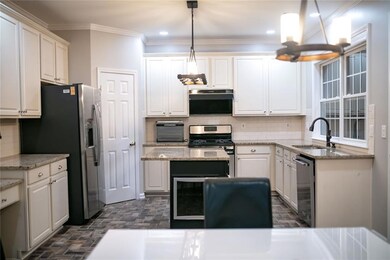 Kitchen with a sink, stainless steel appliances, w