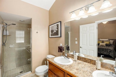 Full bath with double vanity, ensuite bath, a shower stall, and light tile patterned floors