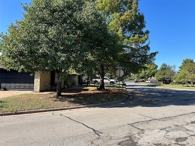 View of front facade with stone siding and concrete driveway