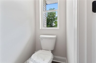 Bathroom with toilet and baseboards