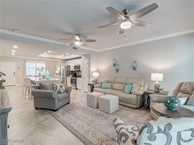 Living room featuring ceiling fan and ornamental m