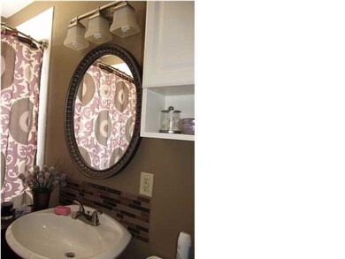 NOTICE THE BATHROOM'S UPDATED MIRROR AND LIGHTING 