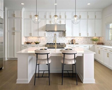 Kitchen featuring a center island, light counterto