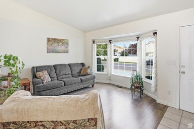 Living area featuring lofted ceiling and wood finished floors