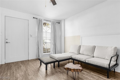 Living area with wood finished floors and ceiling fan