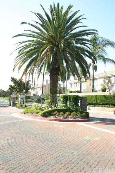 Pavers and a majestic palm greet you at the gate