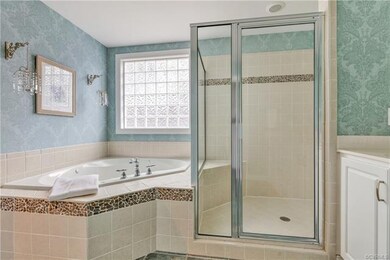 Master Bathroom with separate tub and shower, dual sinks, water closet and ceramic tile floors.