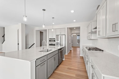 This stunning kitchen combines style and functionality.  Extensive durable quartz counter space perfect for meal prepping.