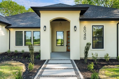 Property entrance featuring a porch, stucco siding
