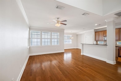 Unfurnished living room with ornamental molding, 