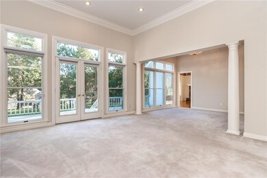 Entry from foyer into living room with 12' ceilings overlooking deck and back yard.  Flows into formal dining.