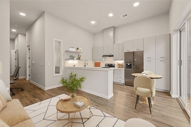 Living room with light wood-style flooring, reces