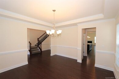 Dining room with tray ceiling, crown mold and pict