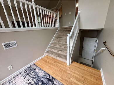 Stairs to basement/garage and living area from front door entry.
