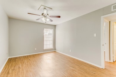 Spare room featuring light wood-style floors and ceiling fan