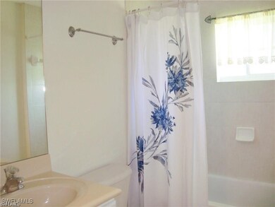 Full bathroom with shower / bath combo with shower curtain, toilet, and vanity