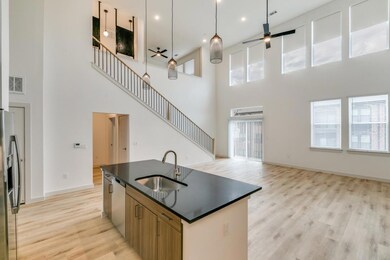 Kitchen featuring visible vents, a sink, dark coun
