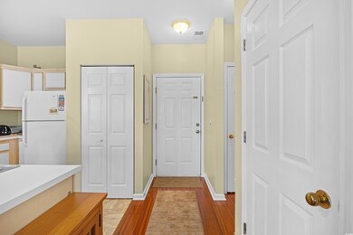 Kitchen featuring freestanding refrigerator, light wood-type flooring, and light countertops