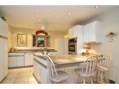 Kitchen. Island  Corian counters  Ceramic tile flo