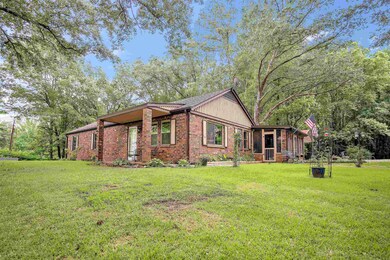 View of front of house with brick siding and a front yard