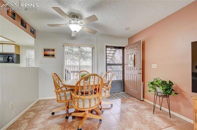 Dining room featuring ceiling fan, light tile patt