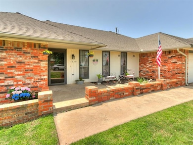 View of front of home featuring roof with shingles, brick siding, and a porch