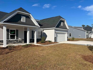 View of front facade with a front yard, covered po