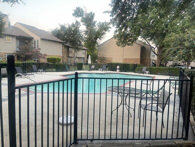 Community pool with a patio area and a residential view