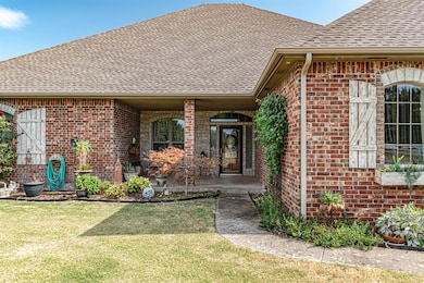 View of exterior entry featuring a lawn