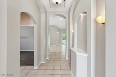 Hallway with arched walkways, light tile patterned
