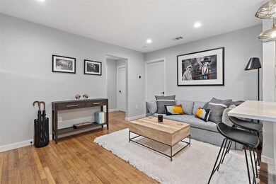 Living room with light wood-style floors, baseboa