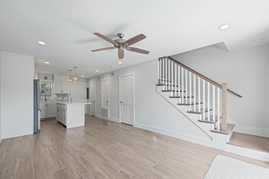 Open-concept main floor with wood-look tile, reces