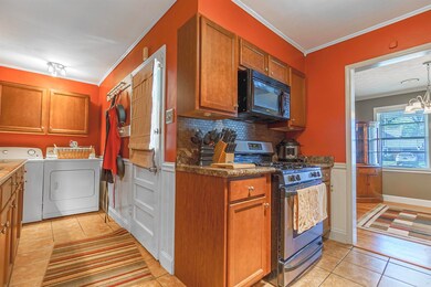 Kitchen with an inviting chandelier, stainless ste
