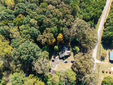 Aerial view of property's location with a forest