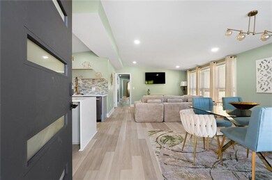 Living room with recessed lighting and light wood-