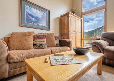 Living area with carpet floors and a mountain view