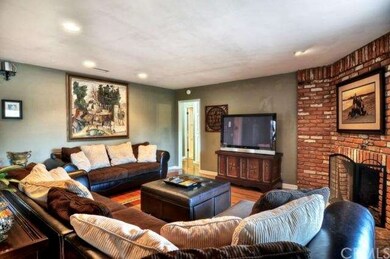 Comfortable Living Room with Large Brick Fireplace