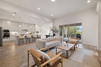 Living room featuring baseboards, light wood fini