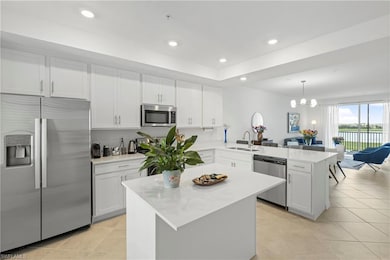 Kitchen featuring stainless steel appliances, white cabinetry, recessed lighting, and light tile patterned floors